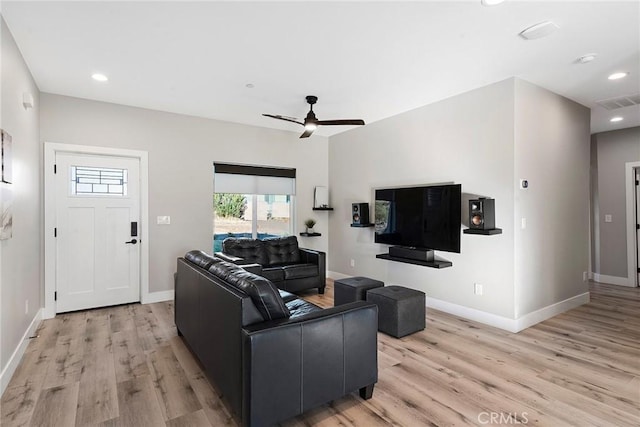 living room with light wood-type flooring, baseboards, and recessed lighting