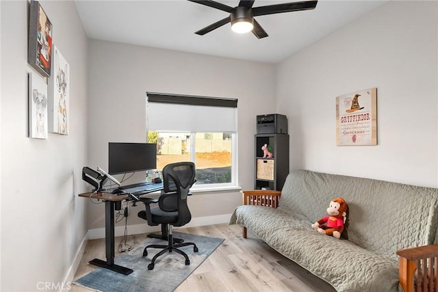 home office with light wood-type flooring, ceiling fan, and baseboards