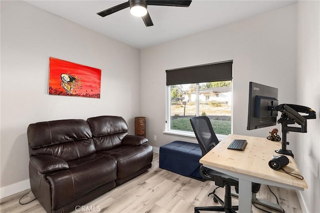 office area with wood finished floors, a ceiling fan, and baseboards