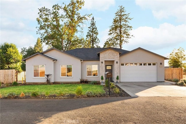 ranch-style house featuring an attached garage, fence, driveway, stucco siding, and a front yard