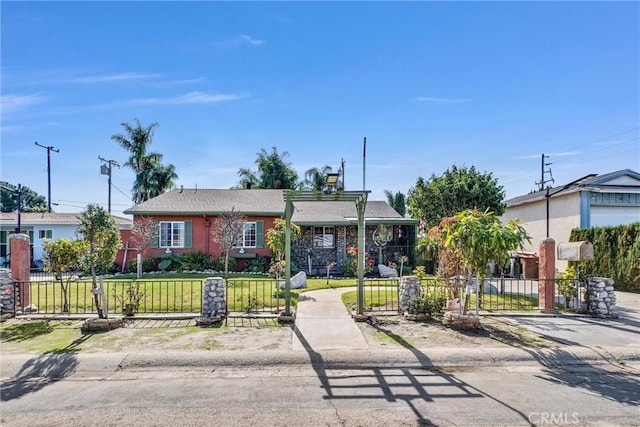 ranch-style home with a fenced front yard, a gate, and a front lawn