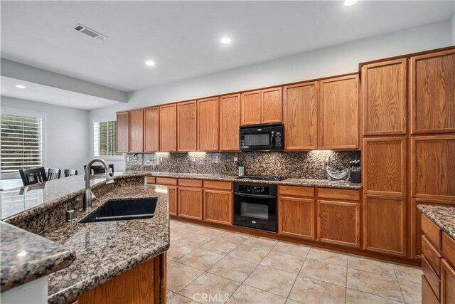 40467 Tiger Way, Palmdale, CA 93551 - kitchen featuring a sink, decorative backsplash, black appliances, and brown cabinets