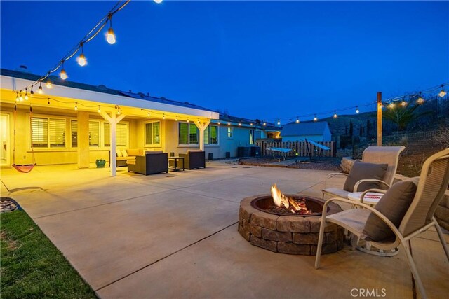 40467 Tiger Way, Palmdale, CA 93551 - patio at twilight with fence and an outdoor living space with a fire pit