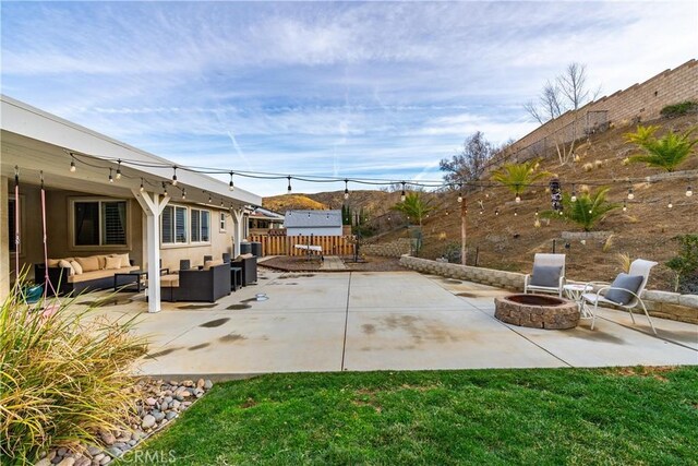 40467 Tiger Way, Palmdale, CA 93551 - view of patio / terrace with a fenced backyard and an outdoor living space with a fire pit