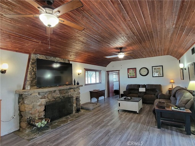 living area featuring a fireplace, ceiling fan, vaulted ceiling, wood finished floors, and wooden ceiling