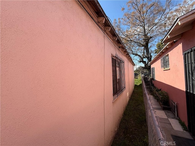 view of side of home featuring stucco siding