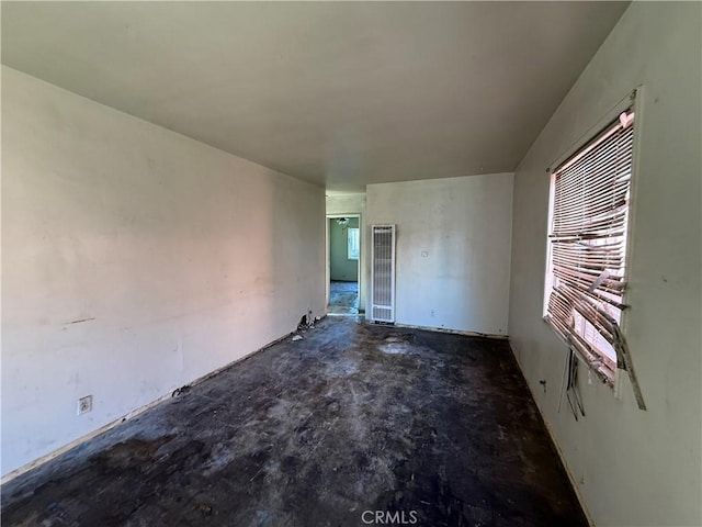 unfurnished room featuring concrete flooring