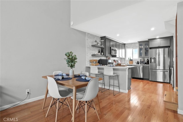 dining area featuring recessed lighting, light wood-style floors, and baseboards