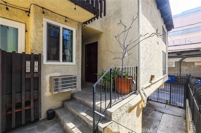 view of exterior entry featuring stucco siding