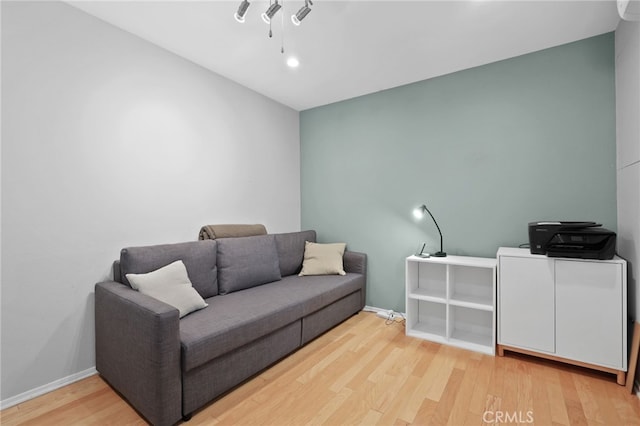 living area featuring wood finished floors and baseboards