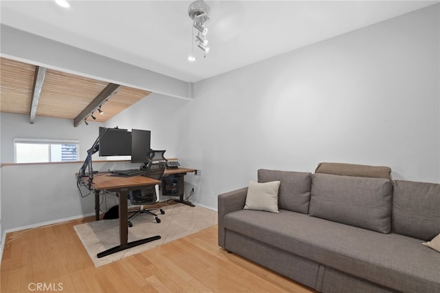home office with lofted ceiling with beams, baseboards, wood finished floors, and track lighting