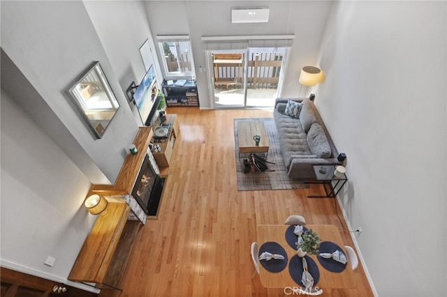 living area with baseboards and wood finished floors