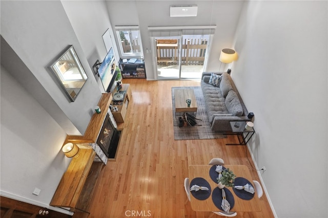 11954 Goshen Ave Unit 205, Los Angeles, CA 90049 - living room featuring wood finished floors and a towering ceiling
