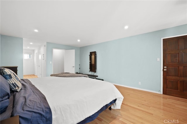 bedroom featuring recessed lighting, light wood-type flooring, and baseboards