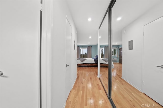 hall with recessed lighting and light wood-style flooring