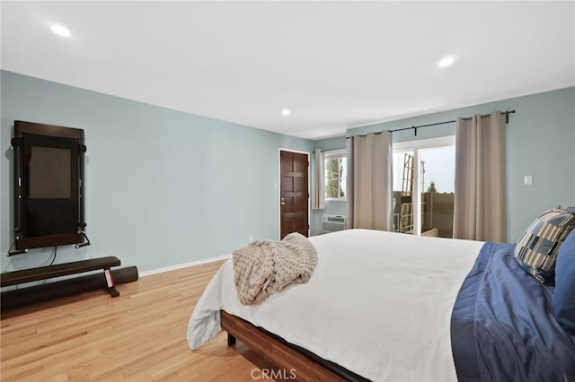 bedroom with recessed lighting, baseboards, wood finished floors, and access to outside
