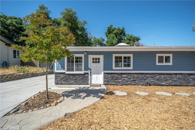 ranch-style house with stone siding