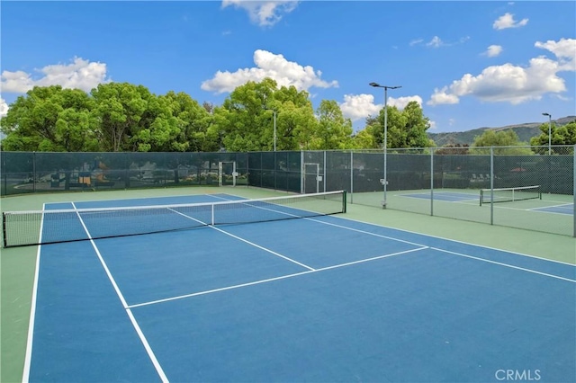 view of tennis court with fence