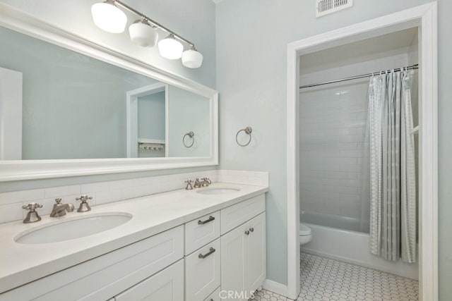 bathroom featuring double vanity, visible vents, a sink, and shower / tub combo with curtain