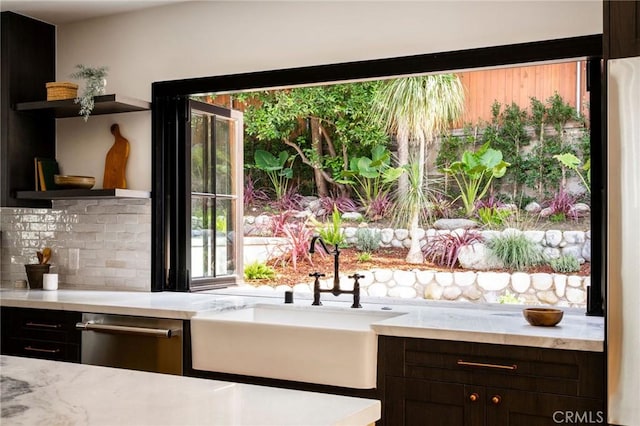 bar with stainless steel dishwasher, tasteful backsplash, fridge, and a sink