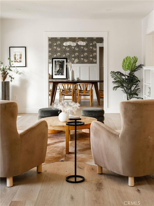 sitting room featuring light wood-style flooring and baseboards