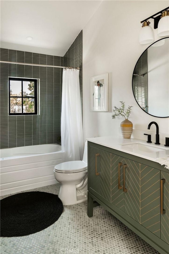 full bath featuring tile patterned flooring, vanity, toilet, and shower / bath combo with shower curtain