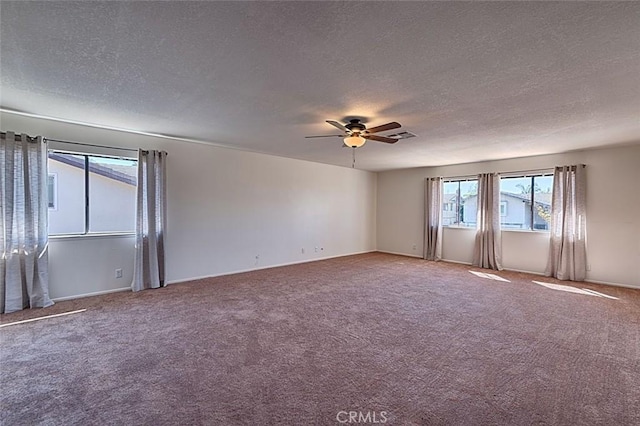 unfurnished room with carpet flooring, a textured ceiling, and a ceiling fan