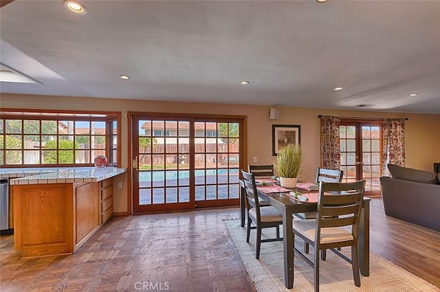 dining space with visible vents, recessed lighting, french doors, and light wood-type flooring