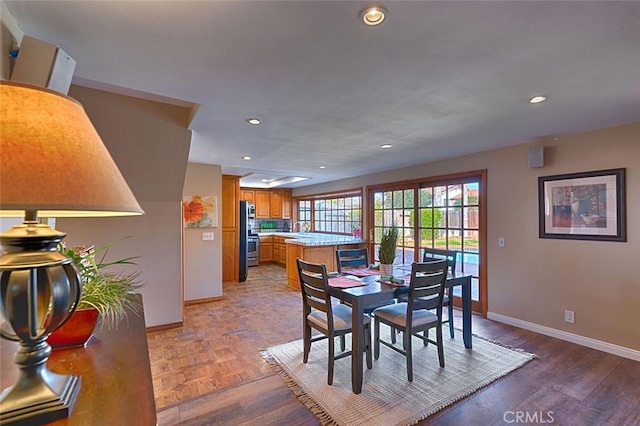 dining space featuring parquet floors, recessed lighting, and baseboards