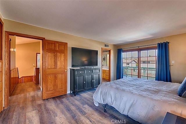 bedroom featuring visible vents, dark wood-style flooring, and access to outside