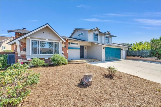 view of front of house featuring board and batten siding, fence, and concrete driveway