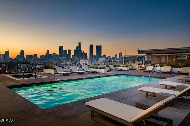 community pool with a city view and a patio