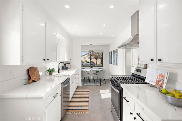 kitchen with stainless steel appliances, a sink, white cabinetry, light stone countertops, and wall chimney exhaust hood