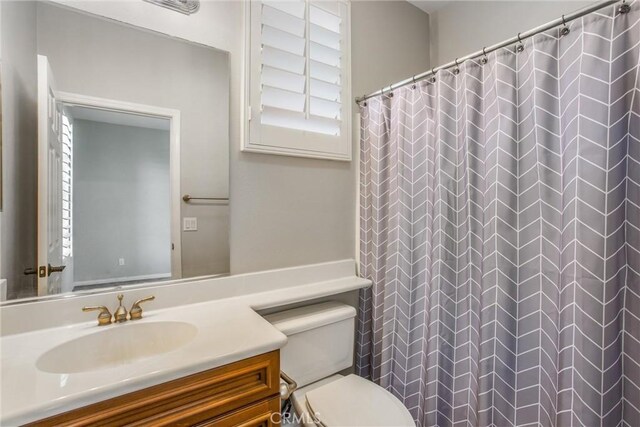60310 Desert Rose Dr, La Quinta, CA 92253 - bathroom with vanity, toilet, and a shower with shower curtain
