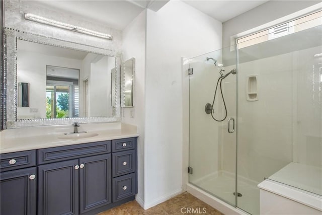 60310 Desert Rose Dr, La Quinta, CA 92253 - bathroom featuring a stall shower, vanity, and baseboards