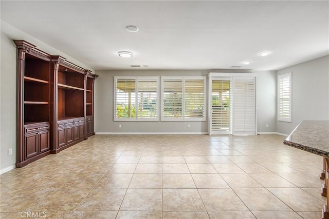 60310 Desert Rose Dr, La Quinta, CA 92253 - unfurnished living room featuring light tile patterned flooring, plenty of natural light, and baseboards