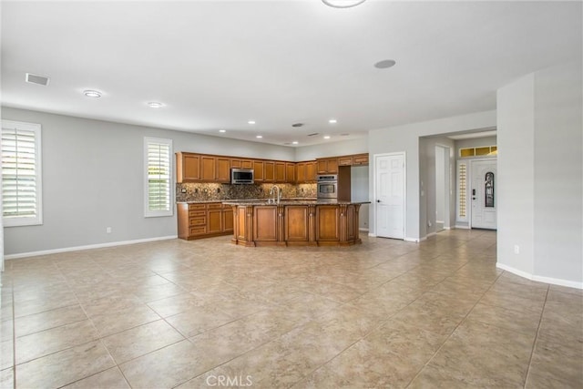 60310 Desert Rose Dr, La Quinta, CA 92253 - kitchen with stainless steel appliances, brown cabinetry, open floor plan, and recessed lighting