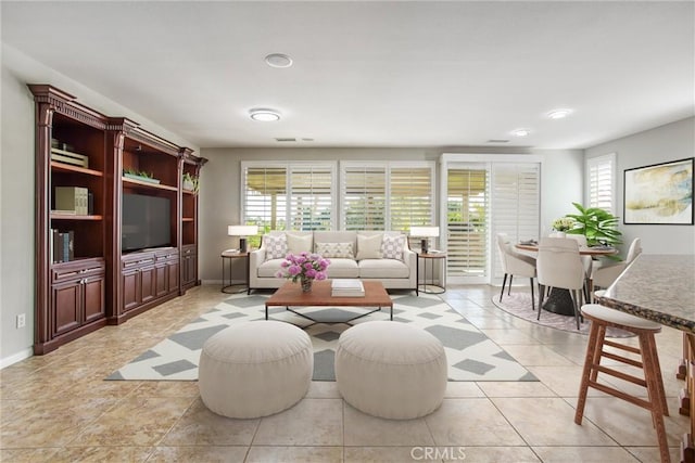 60310 Desert Rose Dr, La Quinta, CA 92253 - living room with healthy amount of natural light, baseboards, recessed lighting, and light tile patterned flooring