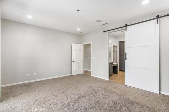 60310 Desert Rose Dr, La Quinta, CA 92253 - unfurnished bedroom featuring carpet flooring, a barn door, recessed lighting, baseboards, and ensuite bath