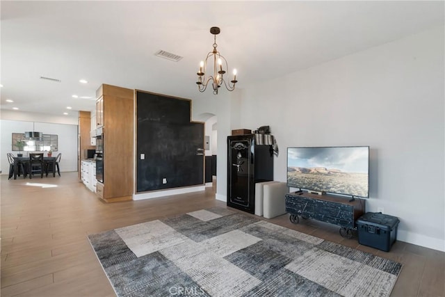 14201 Ross Ct, Rancho Cucamonga, CA 91739 - living room featuring light wood-type flooring, a chandelier, recessed lighting, and arched walkways