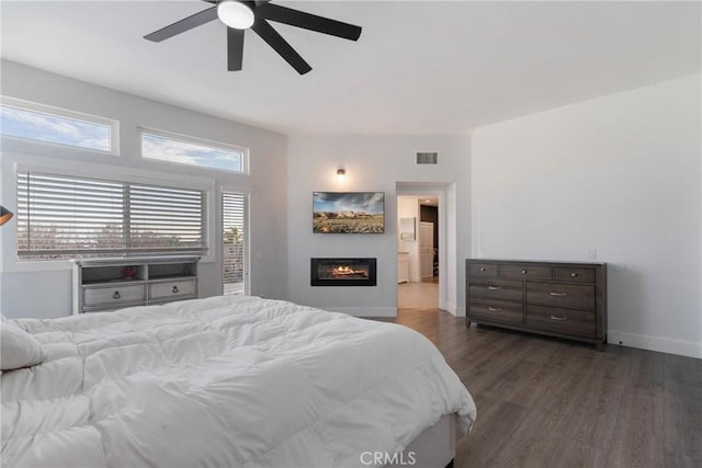 14201 Ross Ct, Rancho Cucamonga, CA 91739 - bedroom featuring dark wood-style floors, a glass covered fireplace, and a ceiling fan