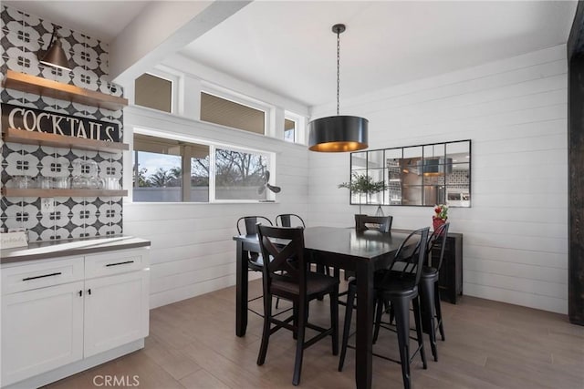 14201 Ross Ct, Rancho Cucamonga, CA 91739 - dining room featuring light wood-style floors and wood walls