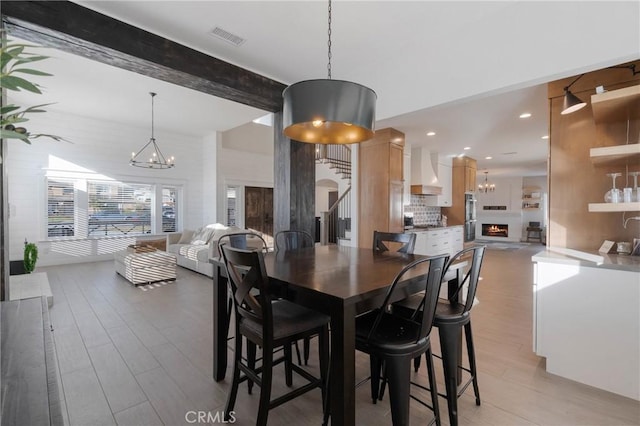14201 Ross Ct, Rancho Cucamonga, CA 91739 - dining area with a chandelier, light wood finished floors, beamed ceiling, recessed lighting, and stairway