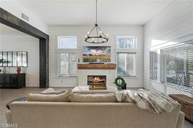 14201 Ross Ct, Rancho Cucamonga, CA 91739 - living area featuring a chandelier, healthy amount of natural light, a brick fireplace, wood finished floors, and wood walls