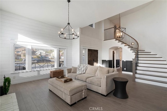 14201 Ross Ct, Rancho Cucamonga, CA 91739 - living area featuring a chandelier, arched walkways, wood finished floors, high vaulted ceiling, and stairs