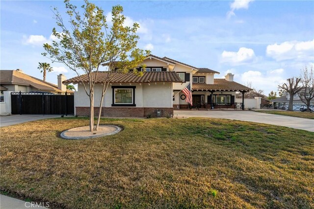 14201 Ross Ct, Rancho Cucamonga, CA 91739 - view of front facade with stucco siding, a chimney, brick siding, and a tiled roof