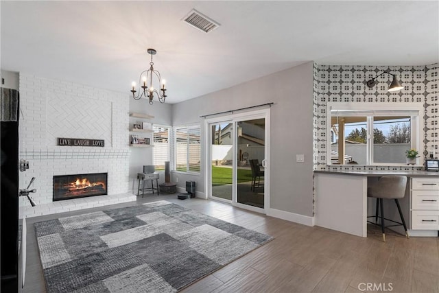 14201 Ross Ct, Rancho Cucamonga, CA 91739 - living room with plenty of natural light, a chandelier, light wood-style flooring, and a fireplace