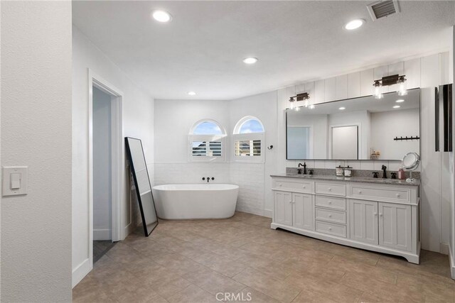 14201 Ross Ct, Rancho Cucamonga, CA 91739 - bathroom featuring double vanity, a freestanding tub, recessed lighting, and tile patterned floors