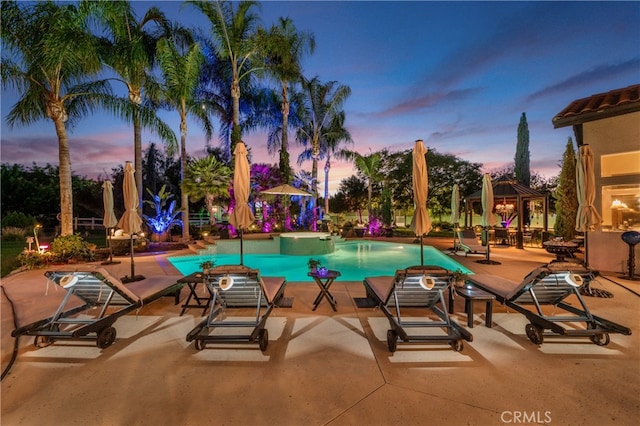 outdoor pool with a patio area and a gazebo