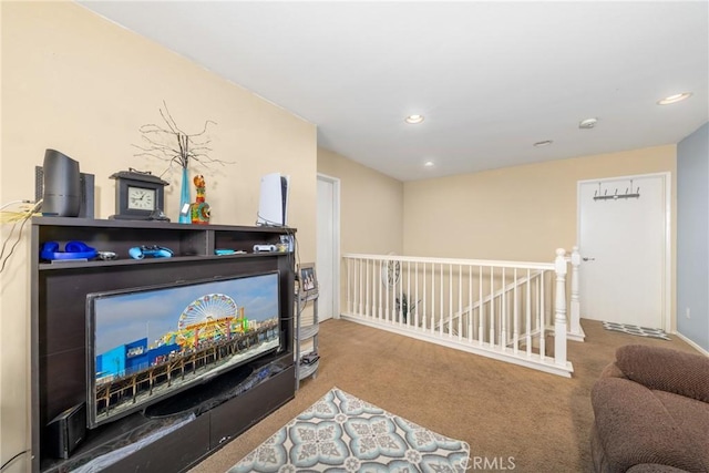 living area with an upstairs landing, carpet flooring, and recessed lighting